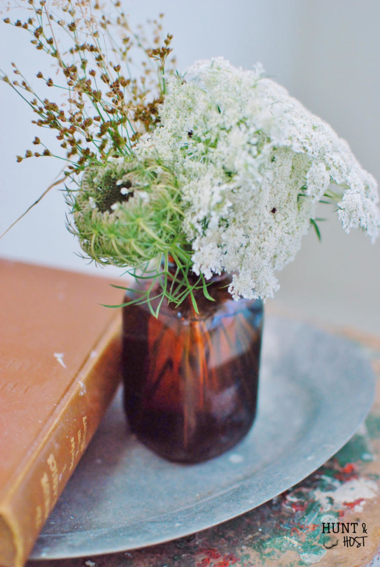 Wild flowers arranged in tobacco jars. www.huntandhost.net