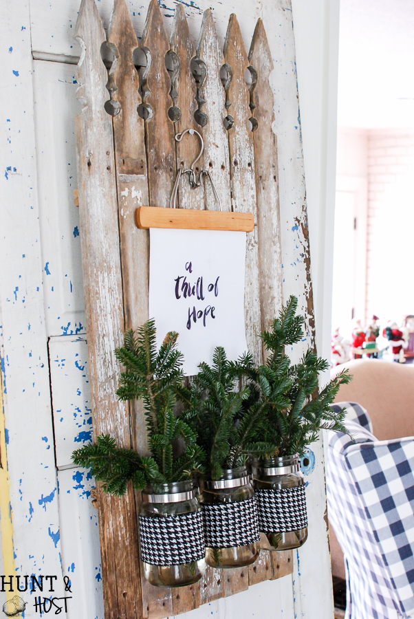 My Christmas farmhouse homes tour, featuring a sled centerpiece, vintage hat boxes, fresh cut greenery and pops of red and green.