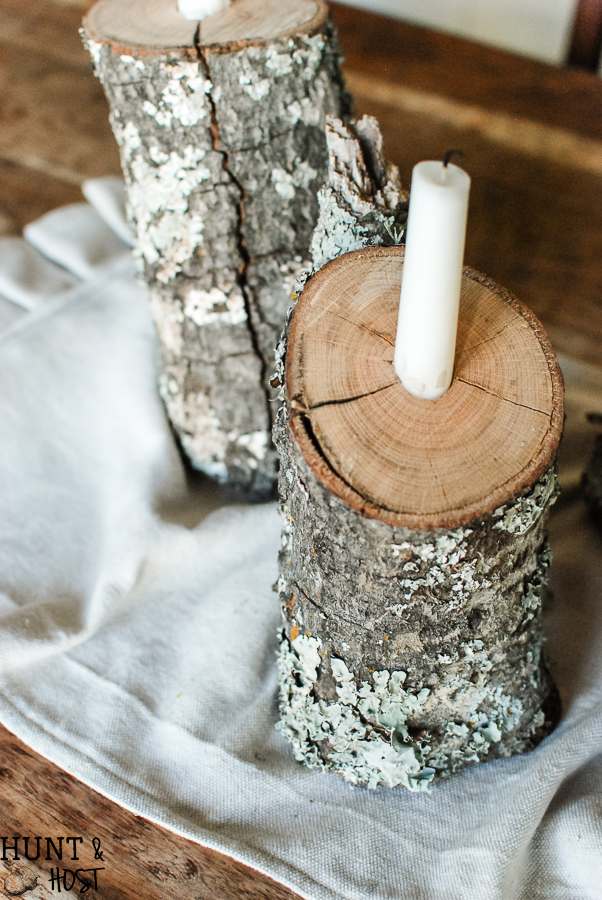 This easy DIY tutorial will show you how to take tossed firewood and turn it into a beautiful rustic winter tablescape by creating log candlesticks.