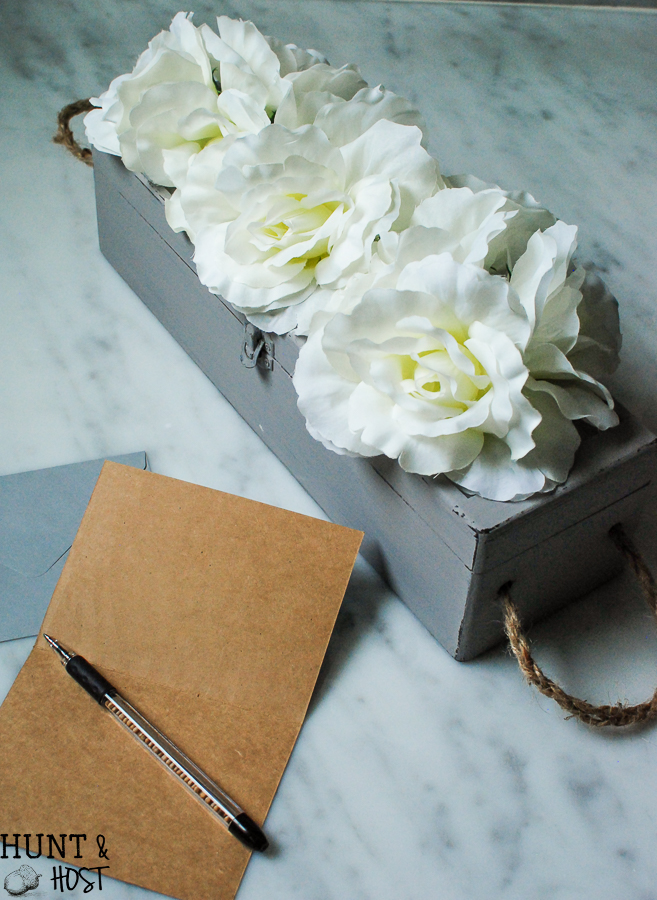 An old wine gift box transformed into a blooming storage box with dollar store flowers. PLUS five other DIY dollar store ideas with flowers.