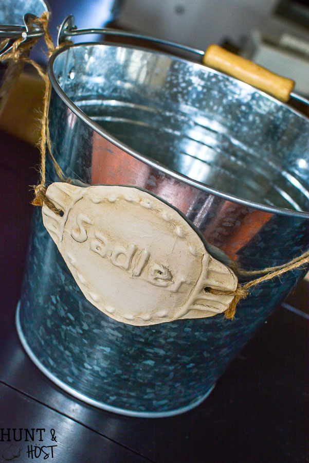 I want to make these cute DIY tin labels for organizing. Can you believe these are dollar store buckets - so many organizing ideas from the dollar store in this article!