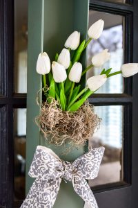 This white tulip wreath for the front door would look great as wall art too. Perfect for your spring decor this upcycled vintage safety deposit box was a unique Round Top Antiques Week find.