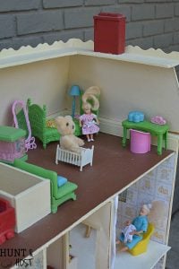 Get lost in in cozy comfort with these dollhouse master bedroom decor ideas. Large scale floral wallpaper make the room a dramatic room with vintage touches, you'll seriously want to move into this dollhouse bedroom! Vintage clocks on the fireplace mantel with a dramatic black and white theme.