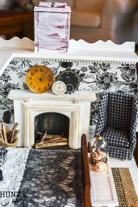 Get lost in in cozy comfort with these dollhouse master bedroom decor ideas. Large scale floral wallpaper make the room a dramatic room with vintage touches, you'll seriously want to move into this dollhouse bedroom! Vintage clocks on the fireplace mantel with a dramatic black and white theme.