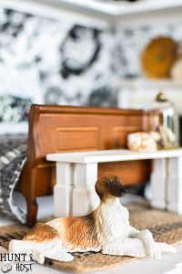 Get lost in in cozy comfort with these dollhouse master bedroom decor ideas. Large scale floral wallpaper make the room a dramatic room with vintage touches, you'll seriously want to move into this dollhouse bedroom! Vintage clocks on the fireplace mantel with a dramatic black and white theme.