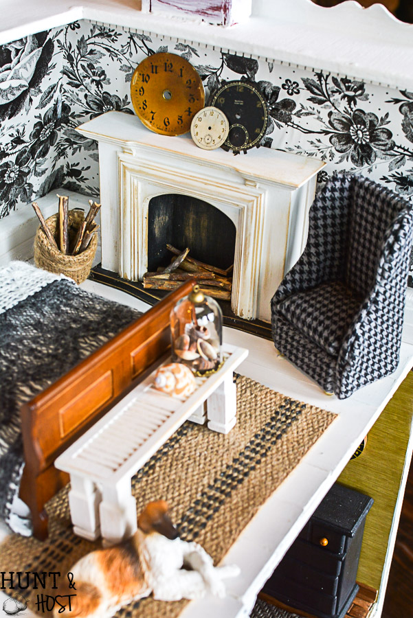 Get lost in in cozy comfort with these dollhouse master bedroom decor ideas. Large scale floral wallpaper make the room a dramatic room with vintage touches, you'll seriously want to move into this dollhouse bedroom! Vintage clocks on the fireplace mantel with a dramatic black and white theme.