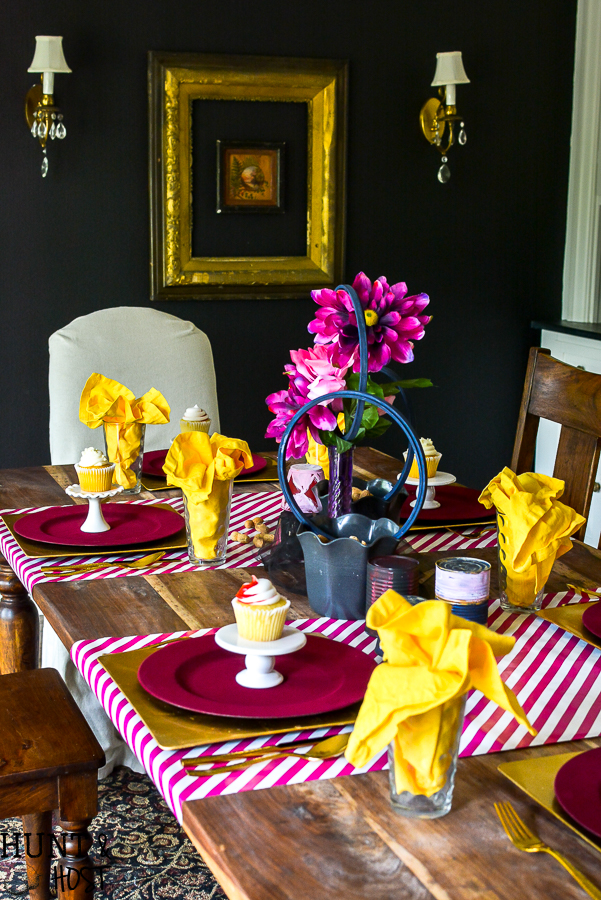 Create a table setting inspired by The Greatest Showman! Perfect for a glam circus theme dinner or just for a cute Greatest Showman tablescape to entertain the family. Anne's pink hair and the smell of peanuts round out this glitzy gold and fuchsia party scene.