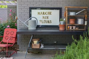 How to make a sleek potting table. This potting bench, painted black is a departure from the chippy white farmhouse look. Plus three must see ideas for professional and fast painted outdoor furniture.