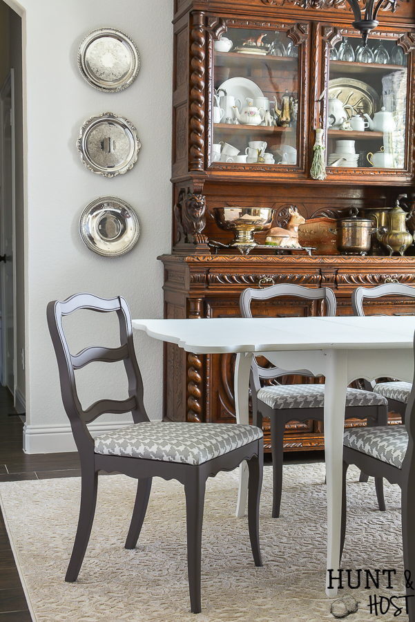 This $40 Facebook Marketplace find gets a makeover. See how this filthy drop leaf dining room table goes to French Country gorgeous in no time. With large print houndstooth fabric and a deep dark paint job these charis are stunning. #frenchcountry #diningroom #cottagedinginroom #farmhousediningroom #paintedfurniture