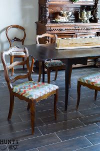 This $40 Facebook Marketplace find gets a makeover. See how this filthy drop leaf dining room table goes to French Country gorgeous in no time. With large print houndstooth fabric and a deep dark paint job these charis are stunning. #frenchcountry #diningroom #cottagedinginroom #farmhousediningroom #paintedfurniture