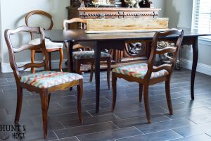 This $40 Facebook Marketplace find gets a makeover. See how this filthy drop leaf dining room table goes to French Country gorgeous in no time. With large print houndstooth fabric and a deep dark paint job these charis are stunning. #frenchcountry #diningroom #cottagedinginroom #farmhousediningroom #paintedfurniture