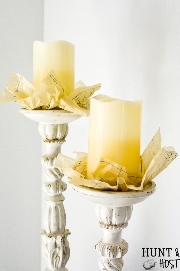 Five Minute Decor Idea! Grab a vintage sewing pattern. an LED candle and a pretty candlestick for some quick and easy vintage decor. Perfect for you thrifted sewing patterns and garage sale candlesticks to come together! #sewingpatternidea #vintagefarmhouse #candlestickdecor #fiveminuteproject #quickDIYdecorating