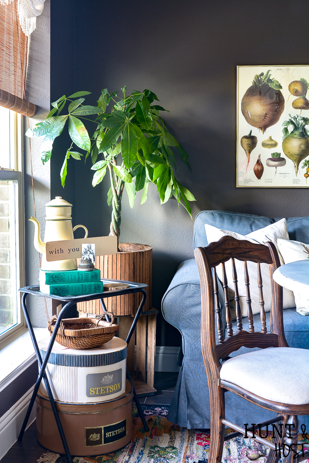 This moody boho vintage breakfast room takes advantage of the vibrant color palette popular in 2019 with a vintage chandelier, dark IKEAS sofa, vintage farmhouse prints and tons of texture you are sure to see some boho decorating ideas you can steal. #bohodecor #vintagestyle #breakfastroomdecor #moodycolors #coloroftheyear #painttrends2019 #vintagechandelier