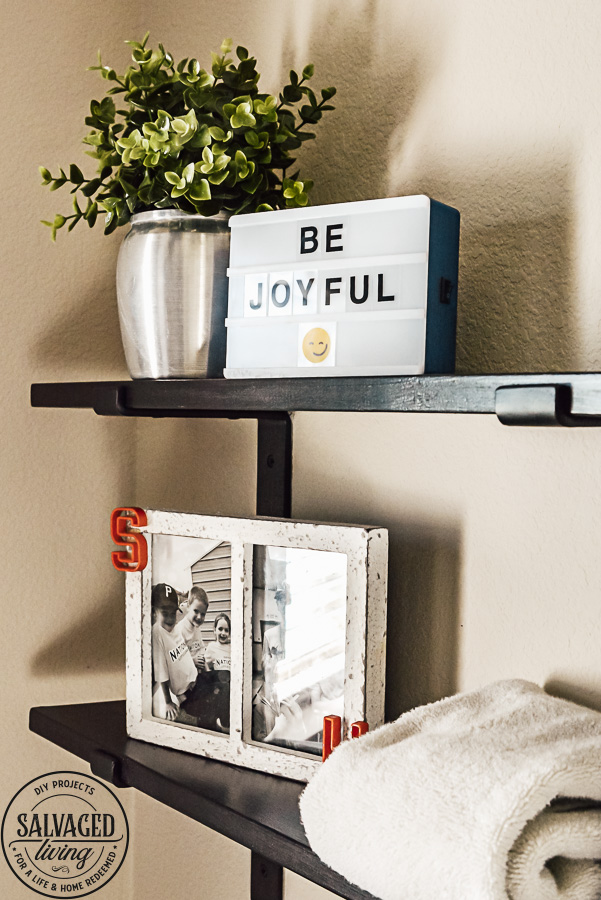 Decorating ideas for a small rustic bathroom. Perfect for a bunch ob boys and a casual cabin bathroom decor. With easy DIY open shelving and faux wall panels, there are some great bathroom decorating ideas here. #rusticbathroom #smallspaceideas #boysbathroom #fauxwallpaper #openshelving #shelfbrackets #DIYstorage #plaidwalls #rusticbathroomcolors #simpleideas