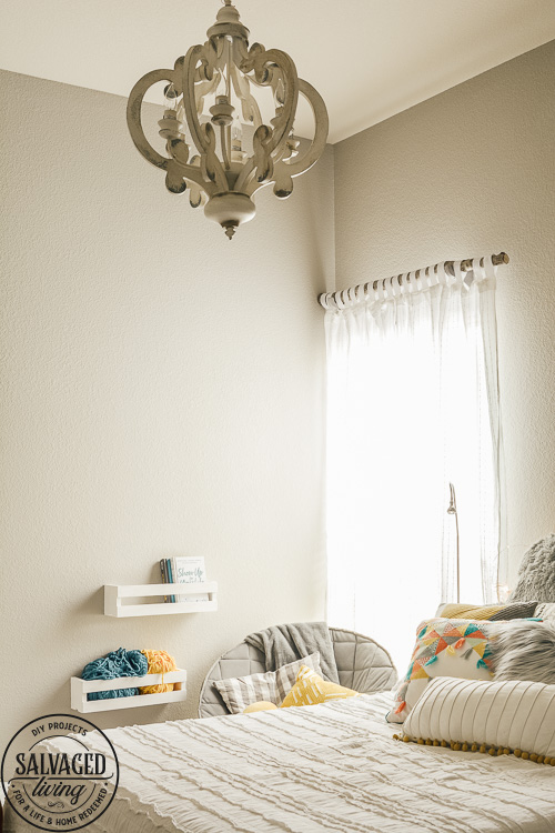 Design a cozy reading corner in your bedroom for a soft and dreamy retreat perfect for getting lost in a good book! Simple touches set the mood for this reading nook! #bookworm #readingnook #readingcorner #bedroomretreat #booknook #cozyreadingcornerforteens #DIYcurtains #bookshelf #cratefurniture