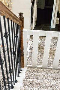 How to build a stylish stairway gate to keep pets or kids out! This easy DIY gate tutorial will look great and blend with your traditional decor. We keep our dog off the carpet with this pet gate. #petgate #stairgate #childproof #DIYpet #cleancarpet #doggate #petgatediy #petgateforstairs