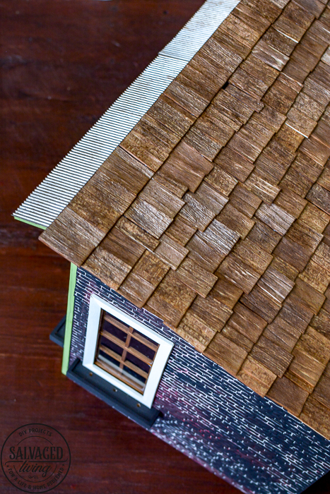 Progress on the creatin' contest miniature garden shed dollhouse. This tiny garden shed is coming along with fun details like a shingled dollhouse roof and upcycled display pieces from old drawers and broken furniture. Miniature crafting is so much fun, join me! #dollhouse #miniatures #gardenshed #miniaturegarden #minitureshop #miniaturecontest #dollhouseDIYideas