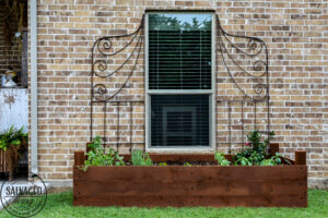 Learn how to spray stain on wood along with tips on how to clean your srpayer when you spray an oil based stain. HINT: it is so much easier than you think! This DIY raised garden bed got a spray stain that will help the wood look good and last longer and it only took minutes to do,. #wagnerspraytech #spraystain #oilbasedstain #paintcleanup #sprayertips #stainedwood #flowergarden #vegetablegarden #raisedbed #landscapedecor #fencestain #diyfencestain