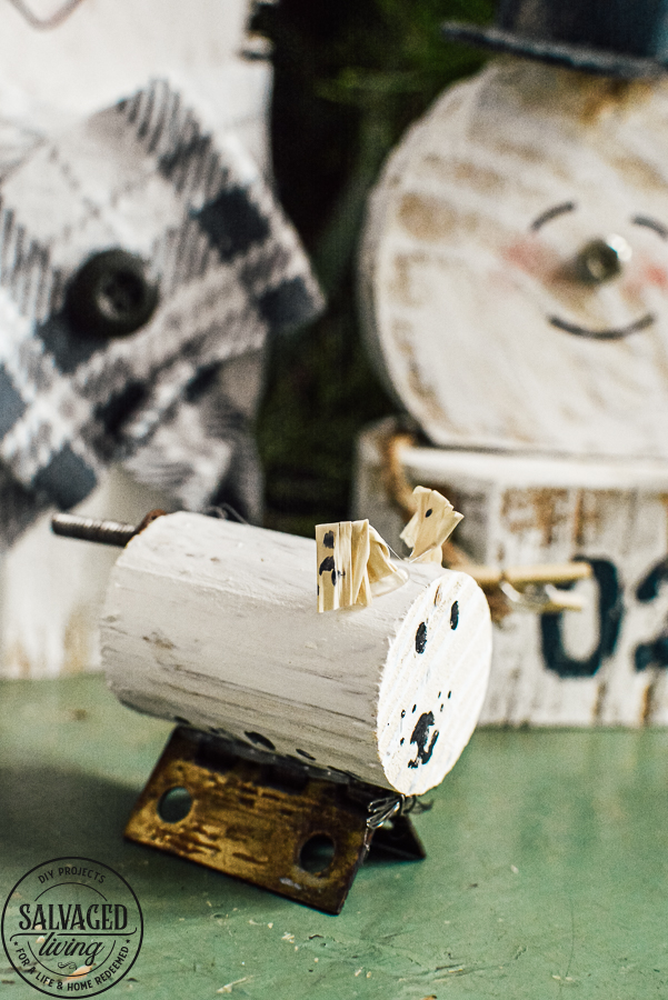 Learn how to make a cheap and easy DIY scrap wood snowmen family. The perfect Christmas decoration or gift idea for a family. This easy snowman craft lets you personalize each snowman face and outfit with junk art from your house! #holidaydecor #handandeChristmas ##snowmancrafts #woodensnowmen #farmhouseChristmas