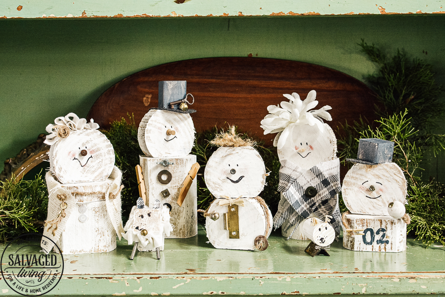 Learn how to make a cheap and easy DIY scrap wood snowmen family. The perfect Christmas decoration or gift idea for a family. This easy snowman craft lets you personalize each snowman face and outfit with junk art from your house! #holidaydecor #handandeChristmas ##snowmancrafts #woodensnowmen #farmhouseChristmas