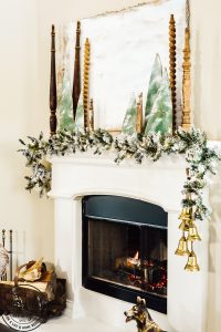 Decorate your mantel with these budget friendly ideas this Christmas! Plus I have a great tip on how to hang garland without nails for damage free decorating! This simple cardboard craft rounds out the Christmas fireplace decorations! #DamageFreeHolidayDecor #CommandDoNoHarm #cardboarddecor #fireplacedecor #vintageChristmas #budgetgarland #easyChristmasdecor