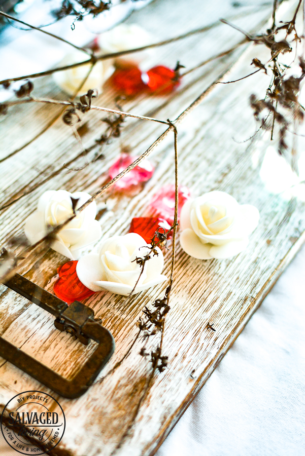 Create a romantic table for Valentine's Day on a tight budget with tons of dollar store crafts mixed with vintage items to bring together a romantic picnic...inside! Bringing the outdoors is always a stylish budget friendly option for holiday decorating! #valentinesdaydecorations #valentinesdaycrafts ##valentinesdaydollarstore #romantictable #farmhousevalentinesday