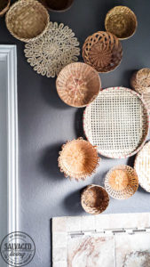 everything you need to know about creating basket gallery wall art. Where to find vintage baskets, how to hang baskets and how to layout a basket gallery wall are all here in this gorgeous gallery wall trend idea. #vintagedecor #wovenbaskets #basketwall #gallerywall