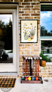 Learn how to hang pictures on brick wall easily with this step by step tutorial. Haning pictures on brick is easy with the right tools and can make your outdoor living space feel like a cozy room in your home. #howtotip #decoratinghack #patiodecoridea