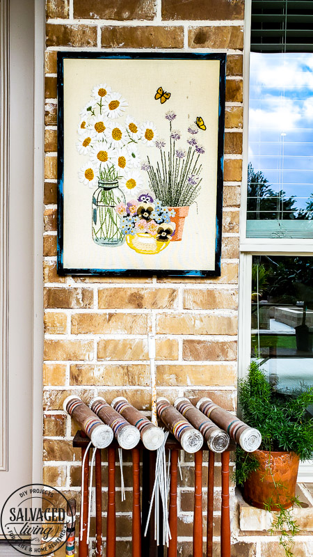 Learn how to hang pictures on brick wall easily with this step by step tutorial. Haning pictures on brick is easy with the right tools and can make your outdoor living space feel like a cozy room in your home. #howtotip #decoratinghack #patiodecoridea