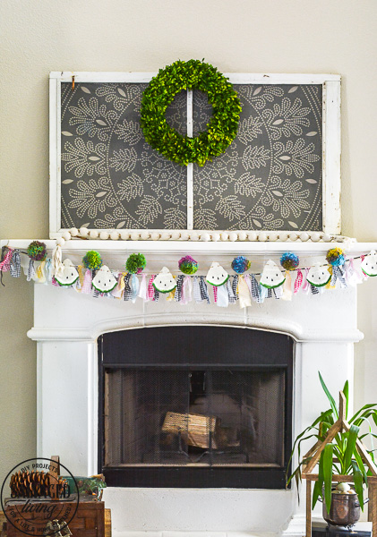 Make this DIY watermelon garland for your summer decor. This budget friendly summer craft is perfect for a summer mantel or summer tablescape! #summerdecor #summercraft #watermelondecor