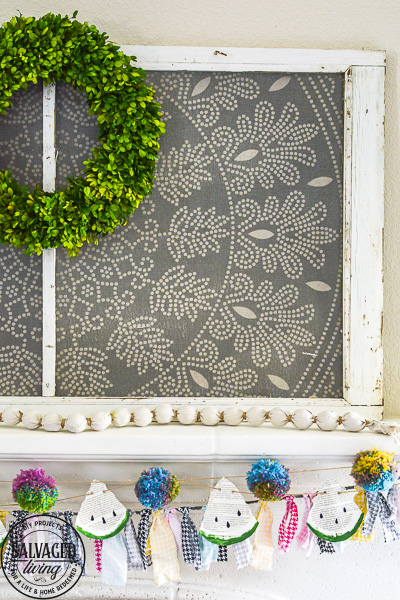 Make this DIY watermelon garland for your summer decor. This budget friendly summer craft is perfect for a summer mantel or summer tablescape! #summerdecor #summercraft #watermelondecor