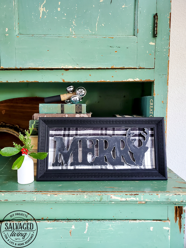 Make a dollar store Christmas sign in no time that looks like gorgeous farmhouse CHristmas decor. This simple dollar tree craft uses an old picture frame to mix old and new for gorgeous dollar store home decor for Christmas. #dollartreecraft #dollartreechristmas #dollarstoreholiday #budgetChristmasdecor #framemakeover