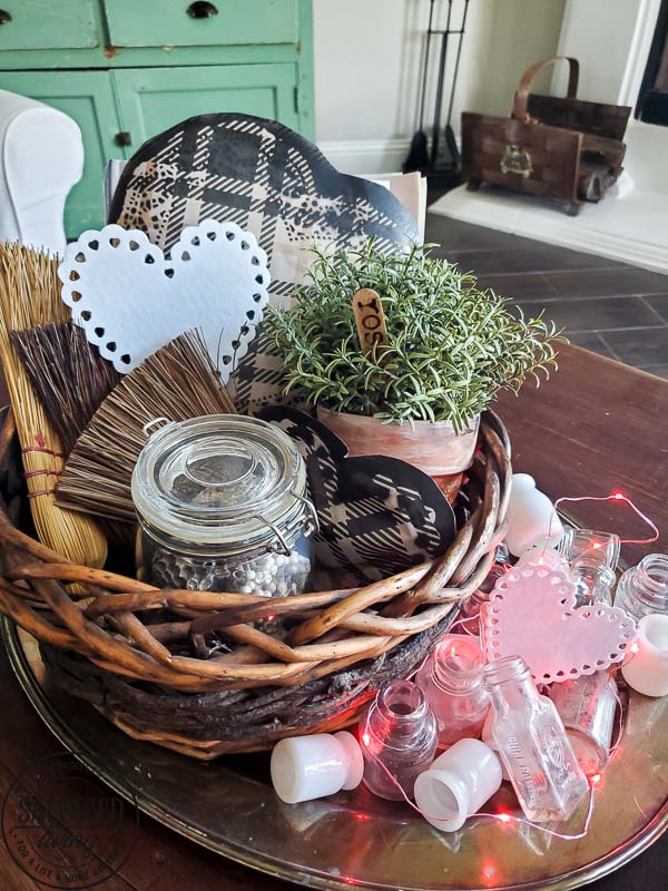 Learn how to make gorgeous giant paper hearts for Valentine's Day decorating on repurposed spindle stands. This dollar store craft is perfect for a farmhouse Valentine theme. #vintageValentine #upcycledprojectidea #spindle #papercraft #stencilart #valentinesdaymantel