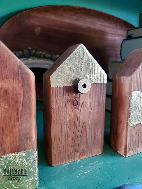 Make your own scrap wood picture holder house with this easy DIY that takes home made up anotch with gold leaf gilding for a modern touch on rustic charm for a great way to display kid's school pictures in style! #schoolpicture #scrapwoodproject #pictureframeidea #goldleafproject