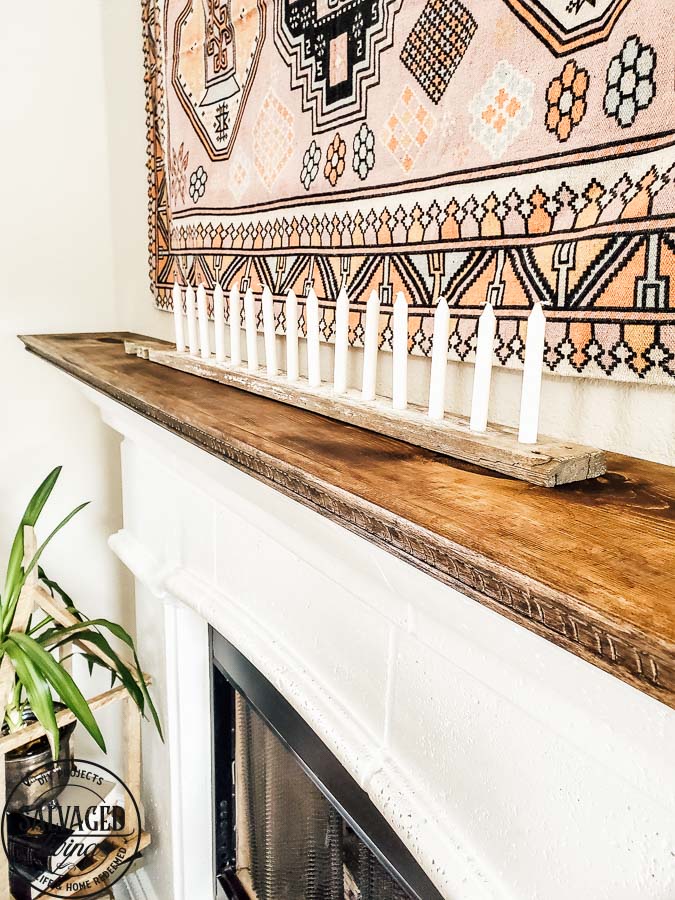 See how to make a stone fireplace mantel into a wood fireplace mantel. This DIY mantel idea is perfect for the person who loves to decorate their mantel but struggles with how to hang deocr on stone mantel or concrete mantel. It is an easy fireplace fix for a more functional fireplace mantel. #woodmantel #DIYmantel #manteldecor #stonefireplaceidea 