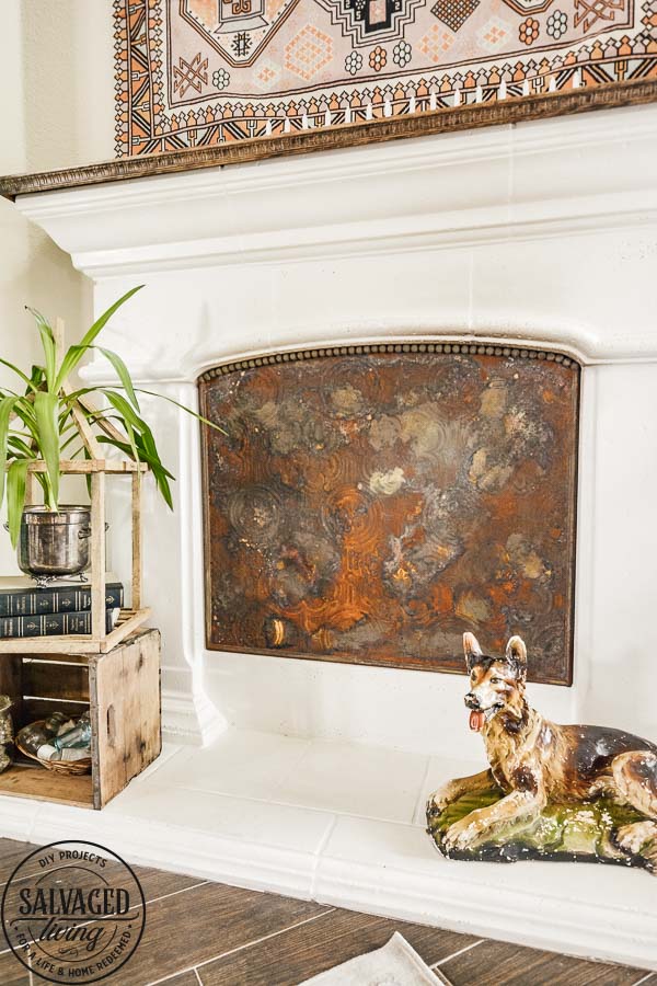 Learn how to make a custom fireplace insert to cover your fireplace opening when you aren't using it for fire. I will show you how to make almost any surface rusty for a vintage fireplace insert that is custom fit to your hearth. This stunning DIY decor project looks so high end and vintage, you will love it. #modernmasters #modernmastersmetaleffects #metaleffects #fireplacedecor #interiordecor #springrefresh #oxidizedfinish #sponsored