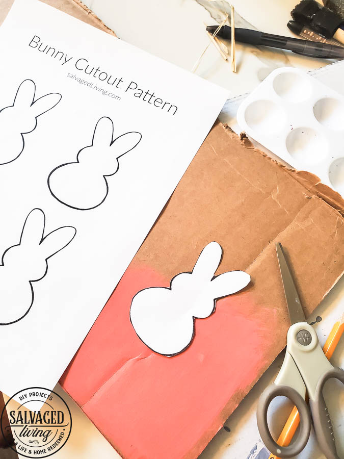 Free pattern to cut out your own Peeps bunny Easter decor. This is the perfect cardboard craft for Easter. Free pattern comes in multiple sizes so you can make peep garland, peep tablesettings, name plates and more for fun Easter decorating. #peeps #easterdecor #cardboardcraft #budgeteaster 