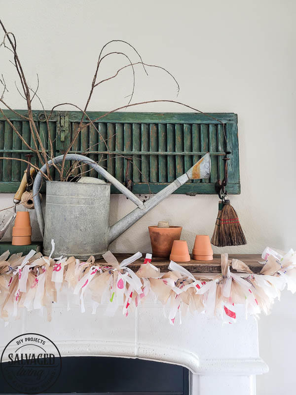 Learn how to make adorable garland from plastic grocery bags you get at the grocery store. his budget friendly DIY idea is perfect for decorating your mantel. #garland #plasticbagcraft #upcycle #budgetdecorideas