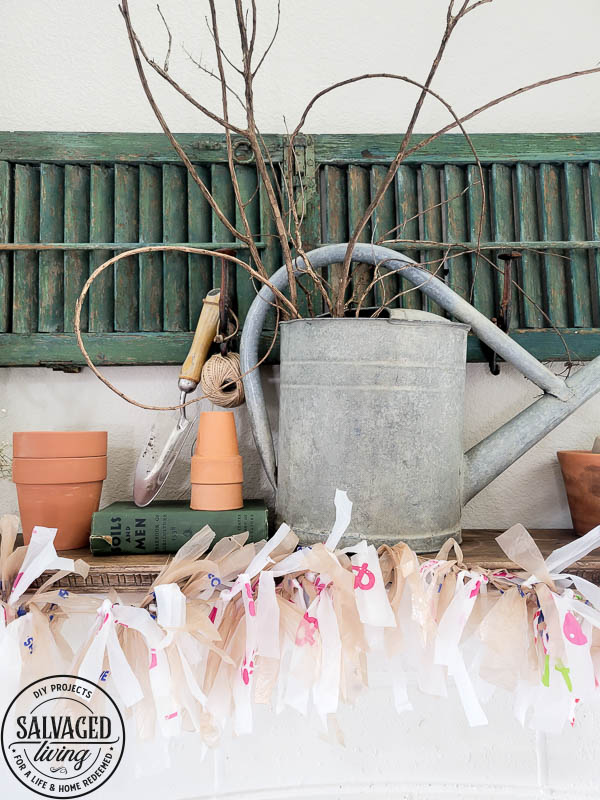 Learn how to make adorable garland from plastic grocery bags you get at the grocery store. his budget friendly DIY idea is perfect for decorating your mantel. #garland #plasticbagcraft #upcycle #budgetdecorideas