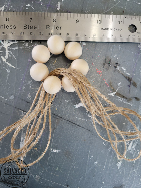 How to make DIY wood bead napkin holders for farmhouse style table settings and budget entertaining. #tablescape #woodbeadidea #vintagestyle #neutraldecor