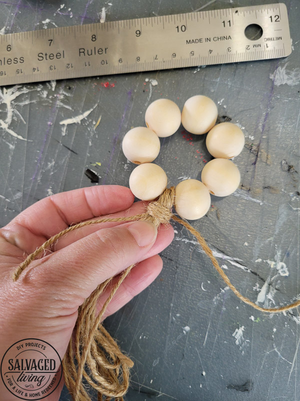 How to make DIY wood bead napkin holders for farmhouse style table settings and budget entertaining. #tablescape #woodbeadidea #vintagestyle #neutraldecor