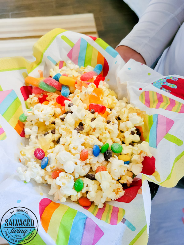 Get a free print out shopping list of the most amazing toppings for a gourmet popcorn bar. A popcorn bar is perfect for entertaining a crowd, it covers all the bases - salty, sweet, savory and sour. I have a list of the perfect popcorn bar ideas for you here! #popcron #crowdpleaser