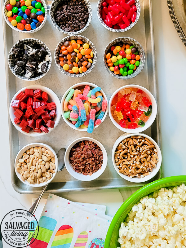 Get a free print out shopping list of the most amazing toppings for a gourmet popcorn bar. A popcorn bar is perfect for entertaining a crowd, it covers all the bases - salty, sweet, savory and sour. I have a list of the perfect popcorn bar ideas for you here! #popcron #crowdpleaser