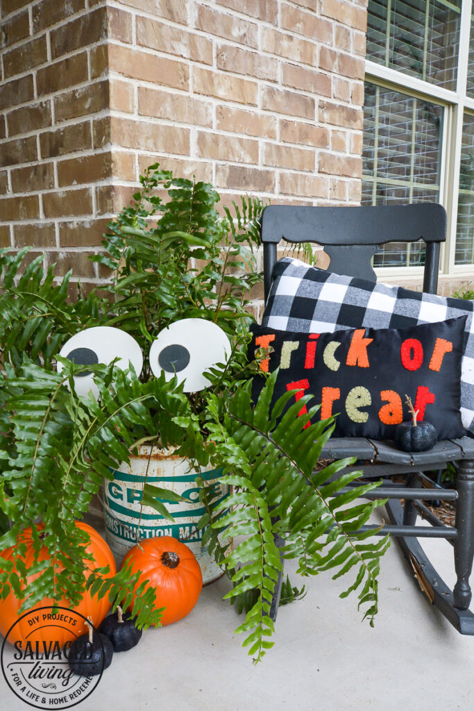 Create a spooky porch for Halloween with DIY glow-in-the-dark outdoor Halloween decor. Perfect for your plants and yard, these glow in the dark eyes bring your outdoor decorating to life! #rustoleum #rustoleumimagine #glowinthedark #halloween #halloweendecor #sponsored #outdoordecor #DIYHalloweencraft