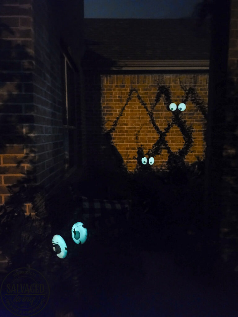 Create a spooky porch for Halloween with DIY glow-in-the-dark outdoor Halloween decor. Perfect for your plants and yard, these glow in the dark eyes bring your outdoor decorating to life! #rustoleum #rustoleumimagine #glowinthedark #halloween #halloweendecor #sponsored #outdoordecor #DIYHalloweencraft