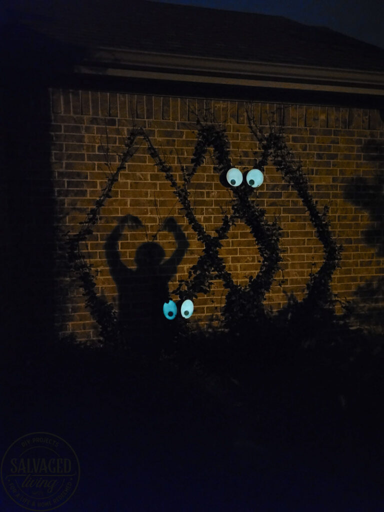 Create a spooky porch for Halloween with DIY glow-in-the-dark outdoor Halloween decor. Perfect for your plants and yard, these glow in the dark eyes bring your outdoor decorating to life! #rustoleum #rustoleumimagine #glowinthedark #halloween #halloweendecor #sponsored #outdoordecor #DIYHalloweencraft