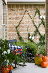 Create a spooky porch for Halloween with DIY glow-in-the-dark outdoor Halloween decor. Perfect for your plants and yard, these glow in the dark eyes bring your outdoor decorating to life! #rustoleum #rustoleumimagine #glowinthedark #halloween #halloweendecor #sponsored #outdoordecor #DIYHalloweencraft
