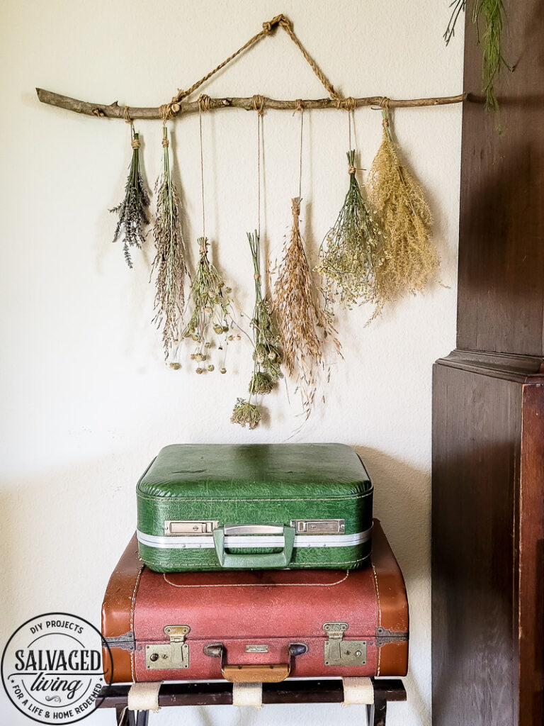 Make a stunning wall hanging from dried flowers and dried grasses for you a boho chic wall hanging in your home. This simple DIY is budget-friendly decor at it's finest! #wallart #driedflowers #bohodecor #farmhousewallart