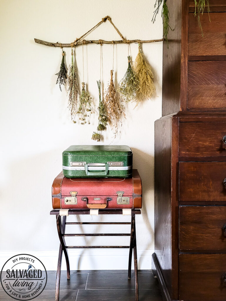 Make a stunning wall hanging from dried flowers and dried grasses for you a boho chic wall hanging in your home. This simple DIY is budget-friendly decor at it's finest! #wallart #driedflowers #bohodecor #farmhousewallart 