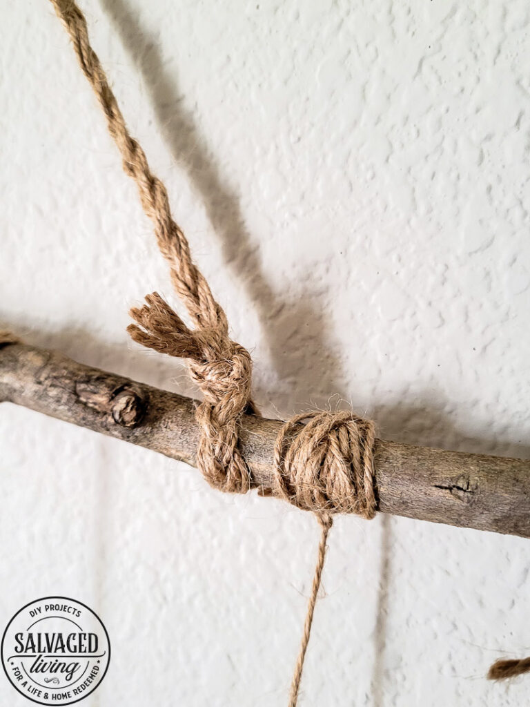 Make a stunning wall hanging from dried flowers and dried grasses for you a boho chic wall hanging in your home. This simple DIY is budget-friendly decor at it's finest! #wallart #driedflowers #bohodecor #farmhousewallart 